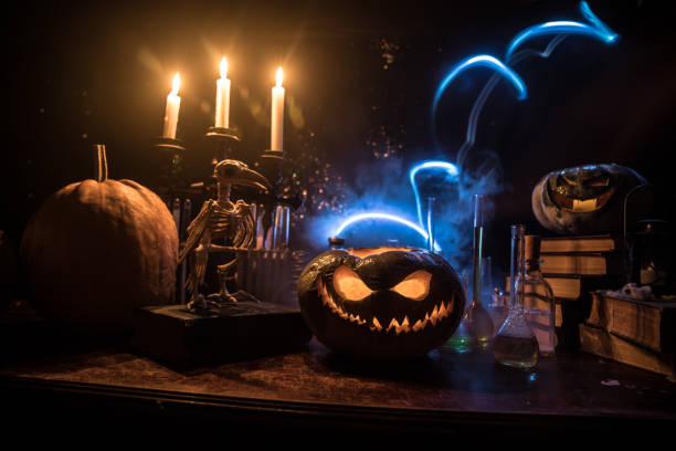 istock Halloween still-life background with different elements on dark toned foggy background. Selective focus 1182521777