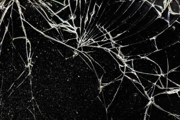 istock white cracked glass with dust on black background, texture 1182522546