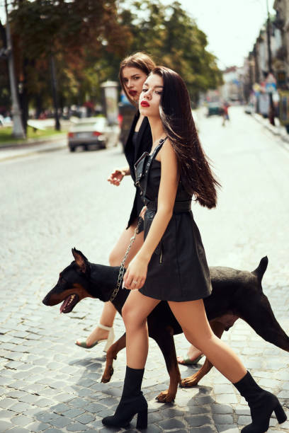 istock Two young fashion models with dog 1182523912