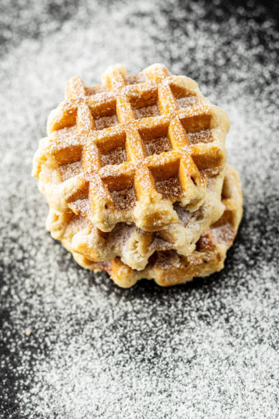 istock Belgian waffles sprinkled with sugar. 1182524012