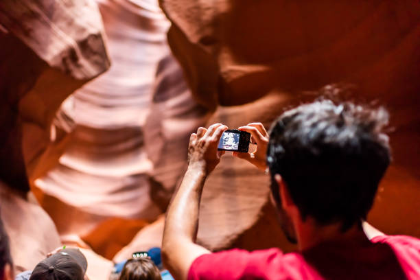 tour group of young man back inside upper antelope slot canyon in arizona taking pictures - 16707 imagens e fotografias de stock
