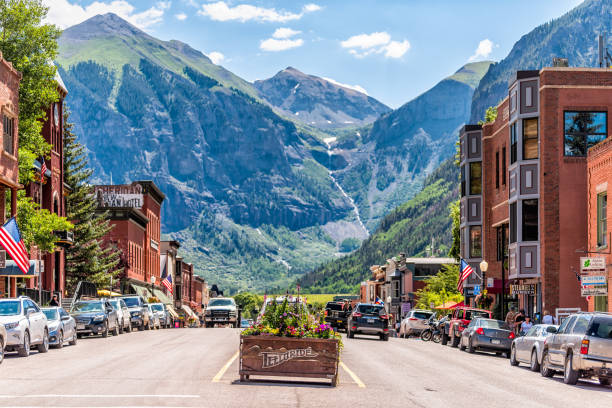 Small town village in Colorado with sign for city and flowers by historic architecture stock photo