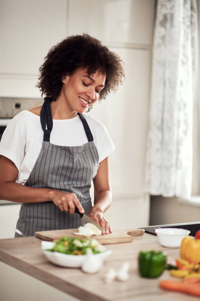 istock Woman chopping mushrooms. 1182525194