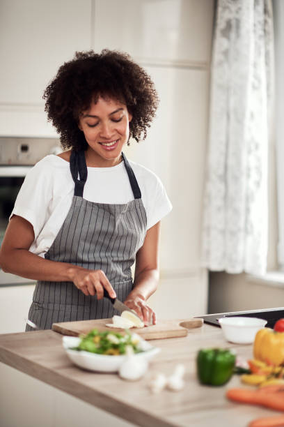 istock Woman chopping mushrooms. 1182525223