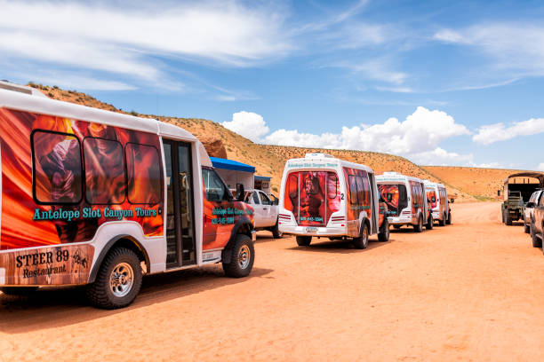 Many colorful shuttle buses parked for Navajo tribal Adventurous photo tours Page, USA - August 10, 2019: Many colorful shuttle buses parked for Navajo tribal Adventurous photo tours at Upper Antelope slot canyon in Arizona page arizona stock pictures, royalty-free photos & images