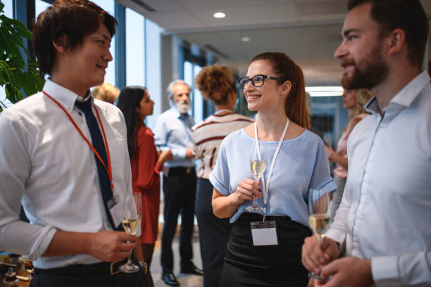 istock Smiling Young Executives Enjoying Sparkling Wine at Party 1182525584