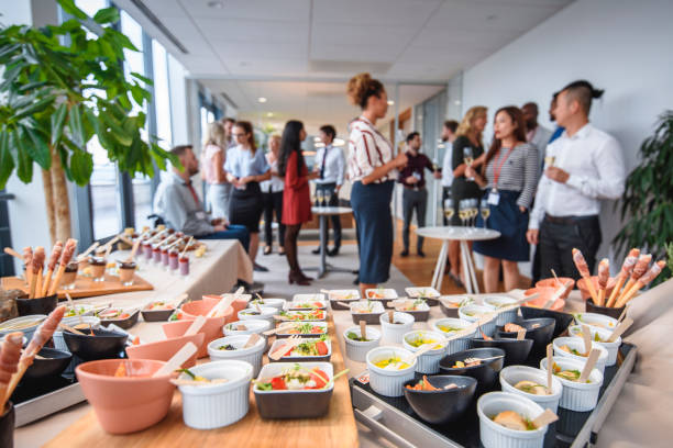 Savory and Sweet Gourmet Food at Corporate Office Party Focus on foreground gourmet small dishes and desserts on buffet tables at new business launch celebration event. work party stock pictures, royalty-free photos & images