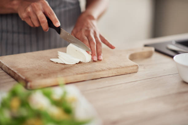 istock Woman cutting mushrooms. 1182526229