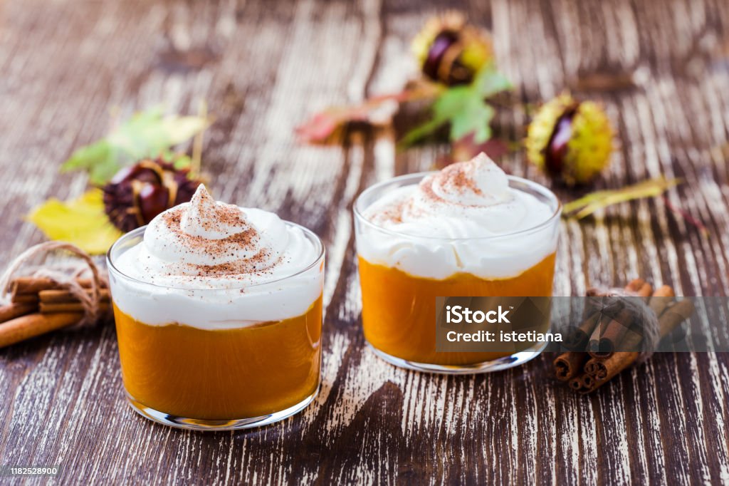 Autumn dessert, pumpkin mousse with whipped cream Autumn dessert, pumpkin mousse with whipped cream in glasses Mousse - Dessert Stock Photo