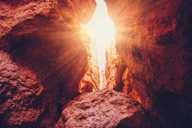 Light shining through rocks in Bryce Canyon, Utah, USA. Sunbeam also called God rays
