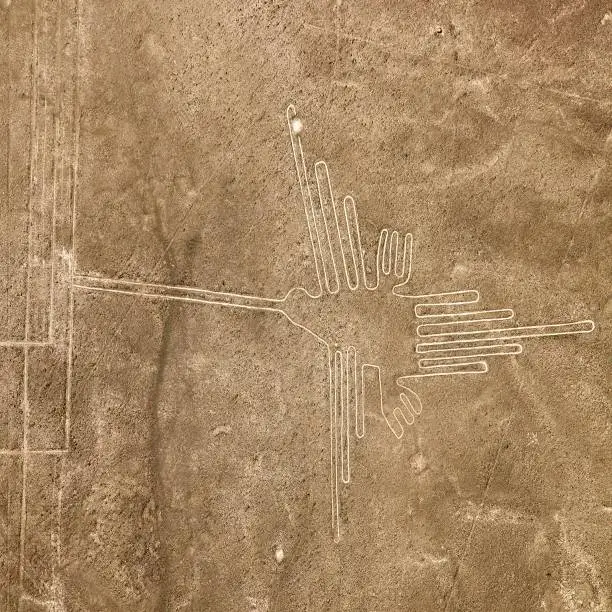Hummingbird geoglyph sepia colored, Nazca mysterious lines and geoglyphs aerial view, landmark in Peru