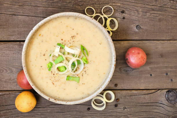 istock Potato and leek soup, top view on a rustic wood background 1182534033