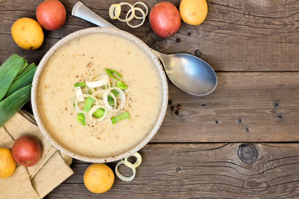 istock Potato and leek soup, above view table scene on a rustic wood background with copy space 1182534034