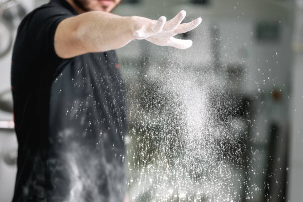 istock Pastry chef, pouring flour in confectionery kitchen. 1182534613