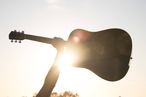 istock Arm holding a guitar in the sun 1182534984