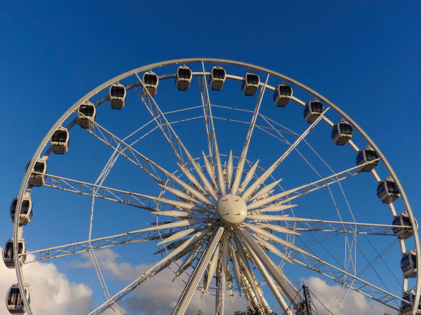 istock Ferris wheel and clouds blue sky 1182534987