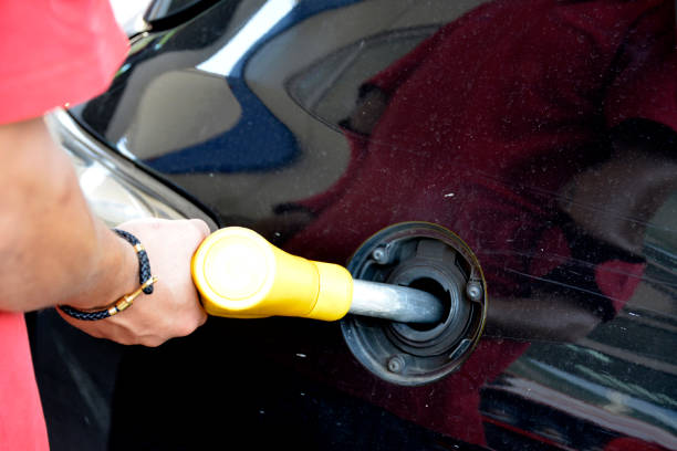 istock Pouring fuel into the car 1182535805