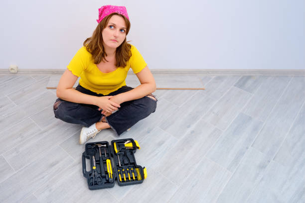 istock A female construction worker is sitting on the floor and looking thoughtfully. DIY construction problem 1182535935