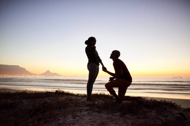 istock Romantic marriage proposal on the beach 1182536689