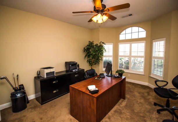 istock Home Office With Wooden Desk & Black File Cabinets 1182536712