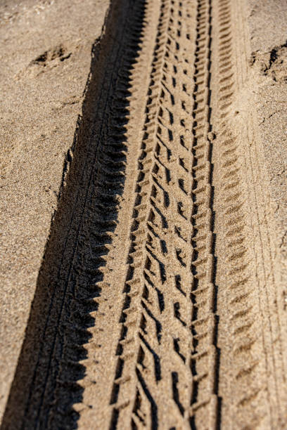 istock Tire mark vehicle on the sand 1182536903
