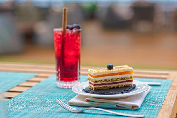 delicious Italian pastries on stone platedelicious Italian pastries on stone plateSummertime refreshment ,cocktails beside swimming pool with flowers and deck chairs with towels.delicious Italian pastries on stone plate