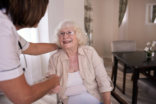 istock Smiling elderly woman shaking hands with her nurse 1182541286