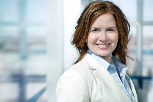 Business woman smiling with building background stock photo