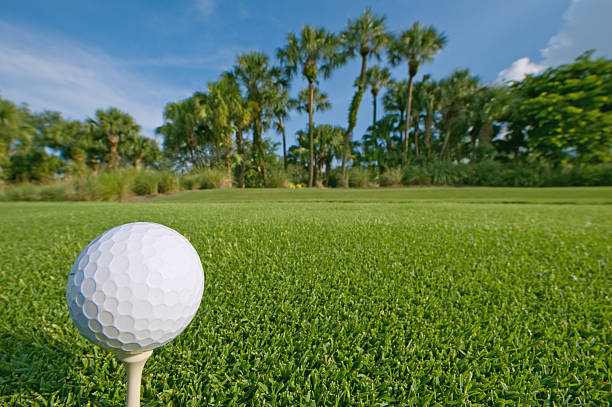 istock golf ball on tee with blue sky above 118254704