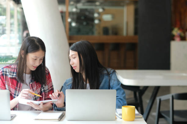 istock girl teenager studying with computer. college high school student taking note 1182549154