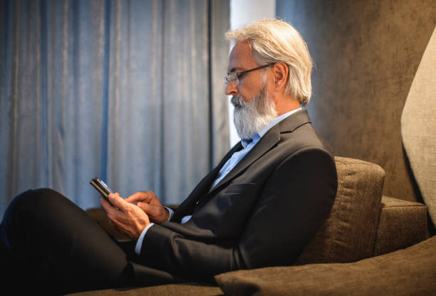 istock Profile of Senior Businessman Using Smart Phone 1182549245