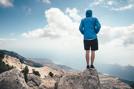 Young man standing on the top of Mount Aenos (Kefalonia island, Greece).