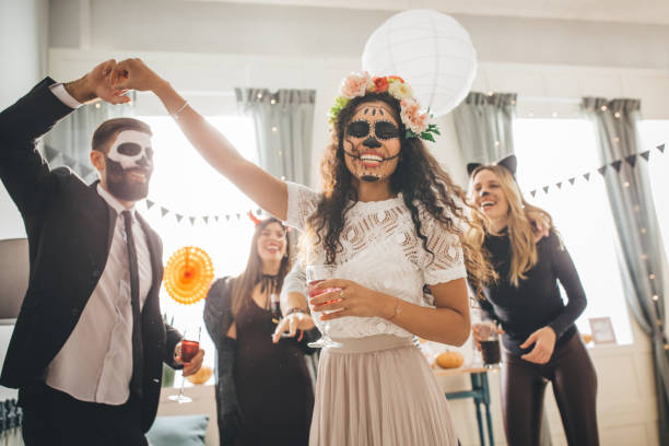 Halloween multi ethnic party Group of Young people at home celebrating Halloween in costumes, they enjoy in good atmosphere carnival costume stock pictures, royalty-free photos & images