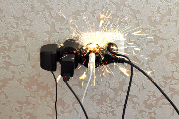 istock Overloaded socket, spark. Danger of electric shock, fire. Wire, plug, fire. 1182553938