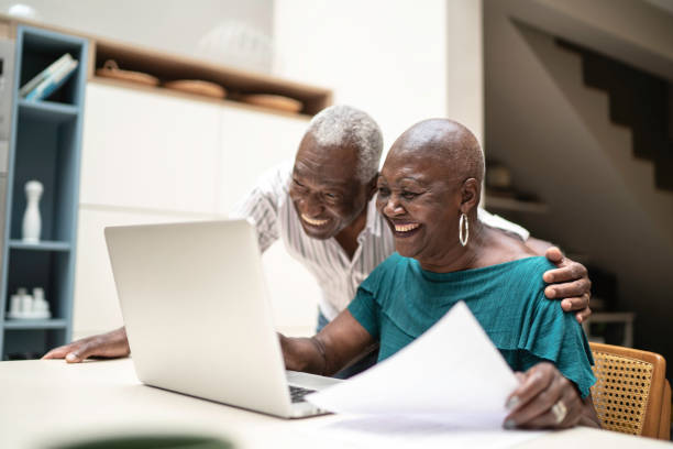 istock Happy senior couple using a laptop at home 1182556998