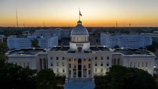 Golden sunlight reaches the horizon showing around the capital statehouse in Montgomery Alabama