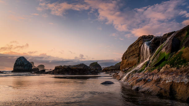 istock Sunset Waterfall Cascade at the Pacific Ocean 1182557859