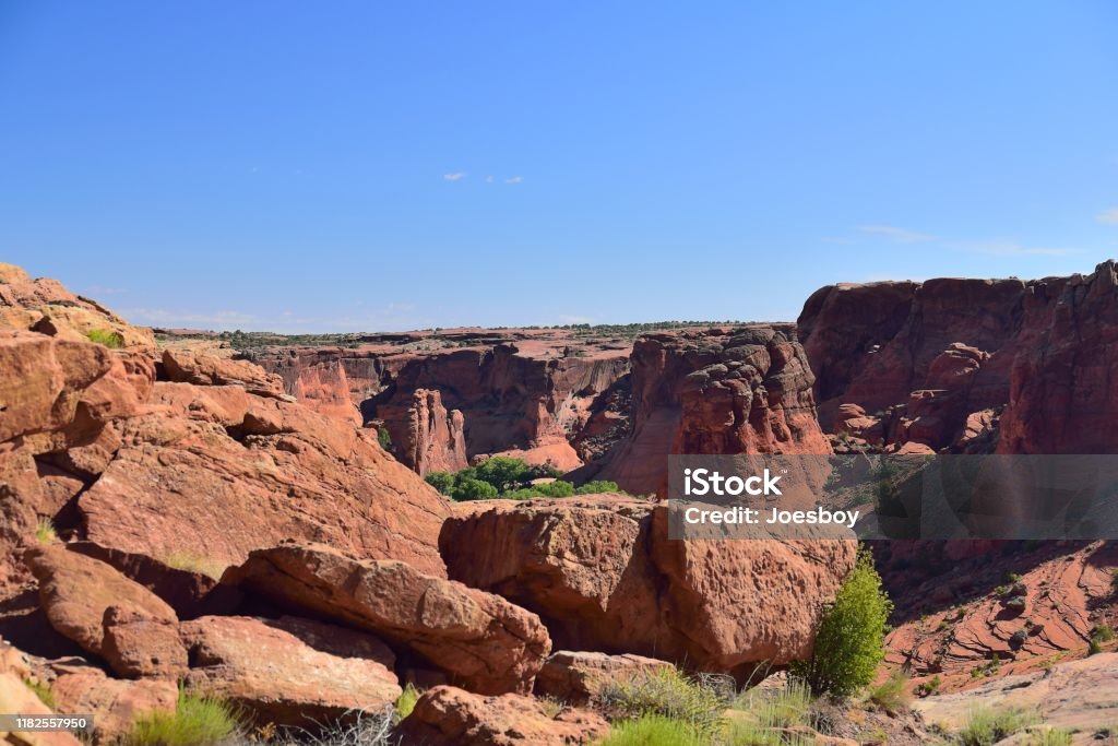 Canyon de Chelly Tunnel Overlook A view of canyon de chilly from the tunnel overlook on the south rim of the canyon with red rocks and blue sky on a summer day Arizona Stock Photo
