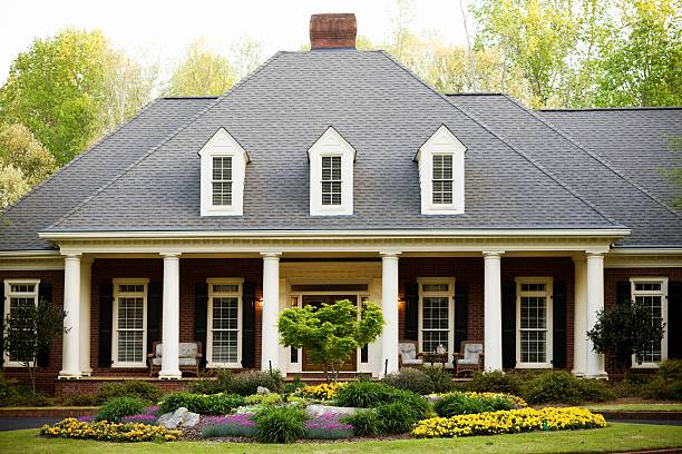 Suburban Home Front filled with flowers American Flag