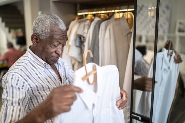 Senior man selecting clothes at home