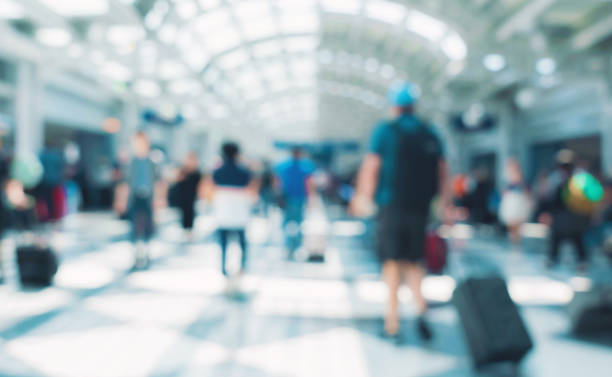 istock Blurred airport interior with people 1182560730
