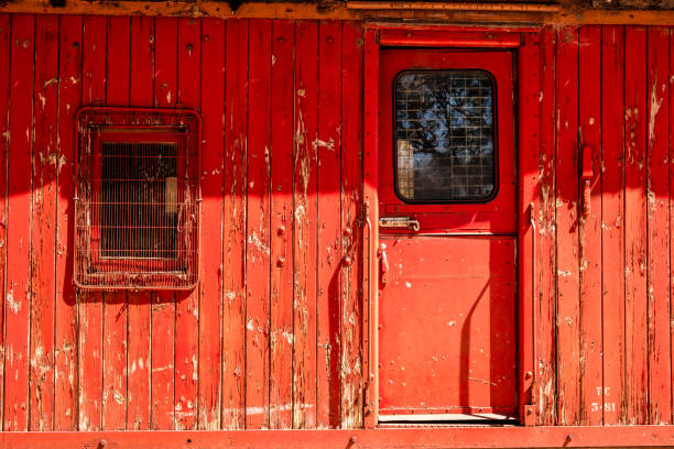 istock Old decaying train carriage with peeling red paint 1182561803
