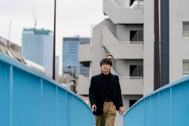 istock Young man walking outdoors 1182564507