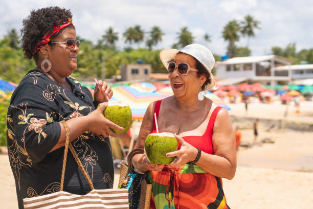 istock Tourists drinking coconut water on the beach 1182565354