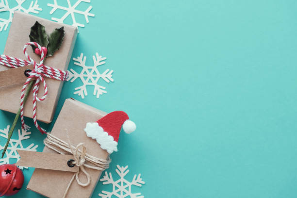 istock Eco gift boxes with Christmas snowflake decoration on green pastel background, Festive holidays background 1182565588