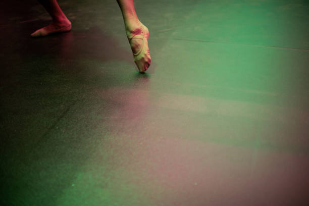 Close-up of a ballerina getting dressed to dance at stage theater