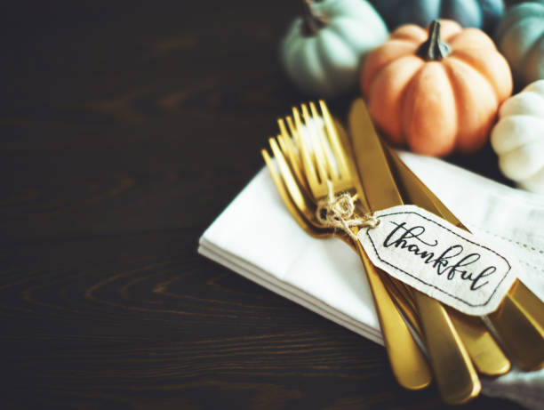 istock Thanksgiving Table Setting Background with Pumpkins and Gold Cutlery 1182573693