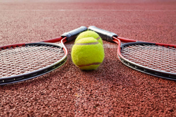 istock Low angle view tennis scene with balls and racquet 1182573827