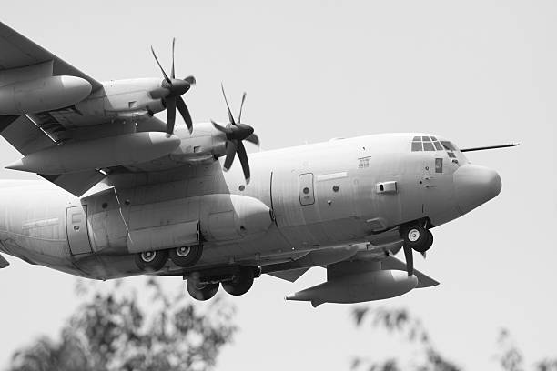 istock Military Airplane Flying in a Grey Sky, BW Image 118257572