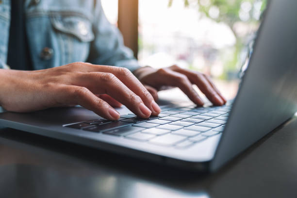 istock a woman working and typing on laptop computer keyboard 1182576315